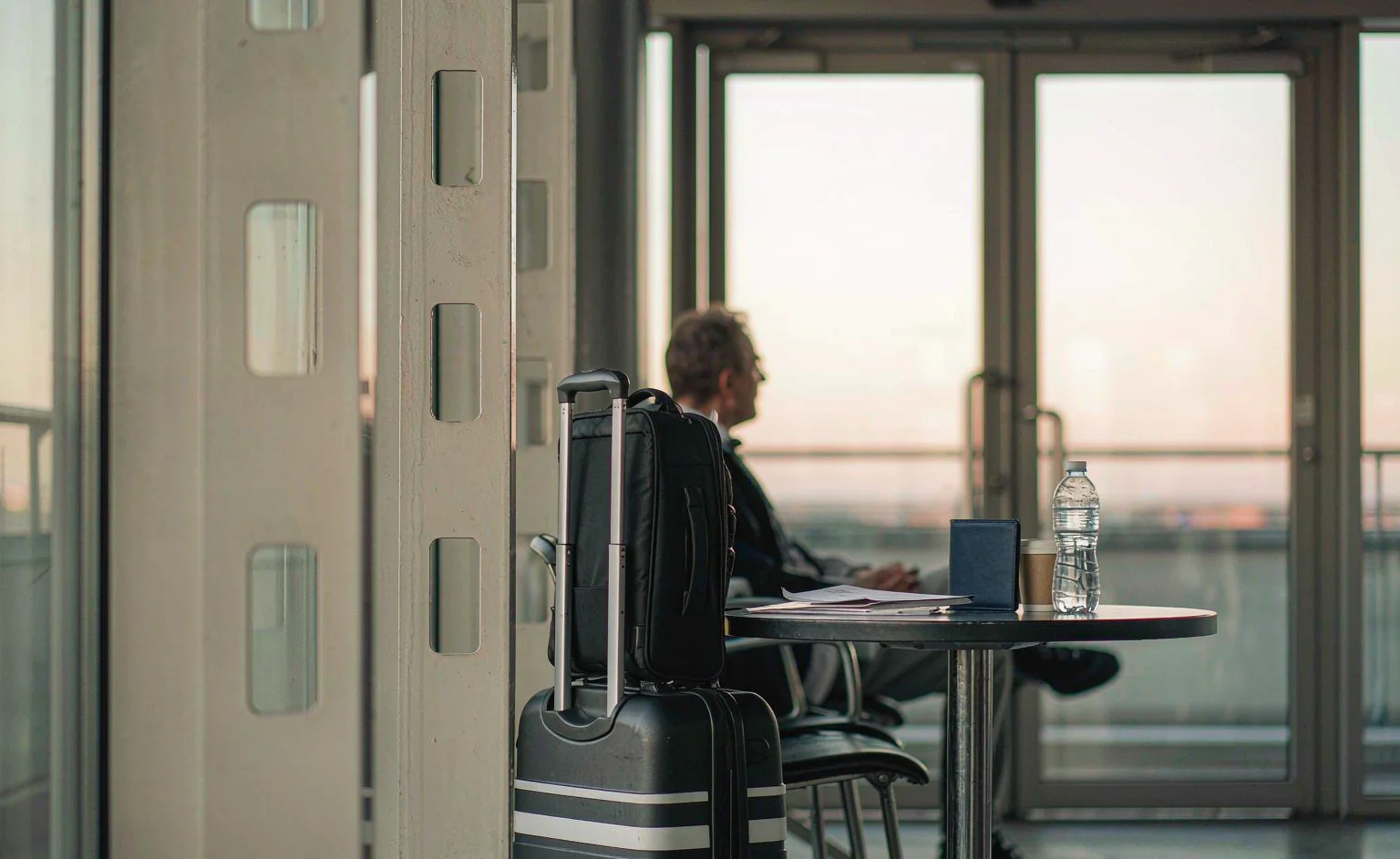 Business traveller preparing trip documents in an airport terminal