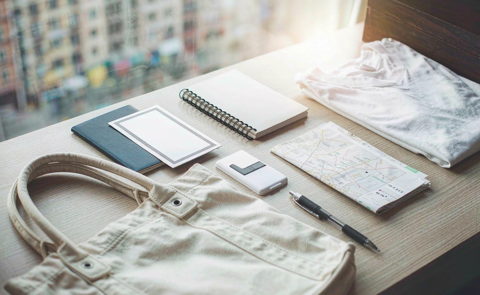 Travel documents, a passport and a fair badge on a desk