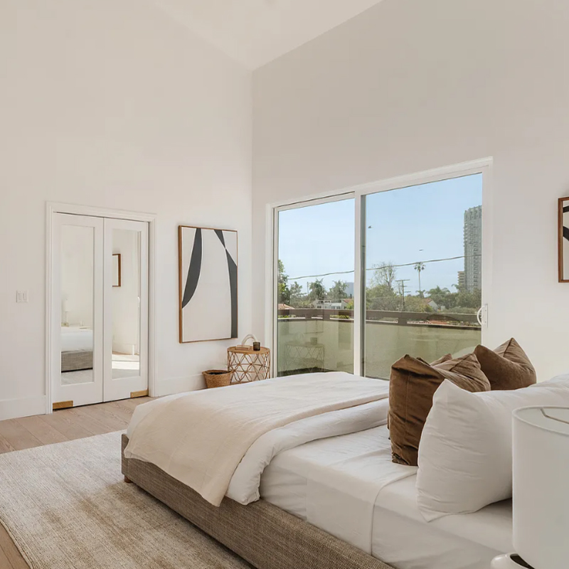 Warm bedroom of a private residence designed by Hymebel